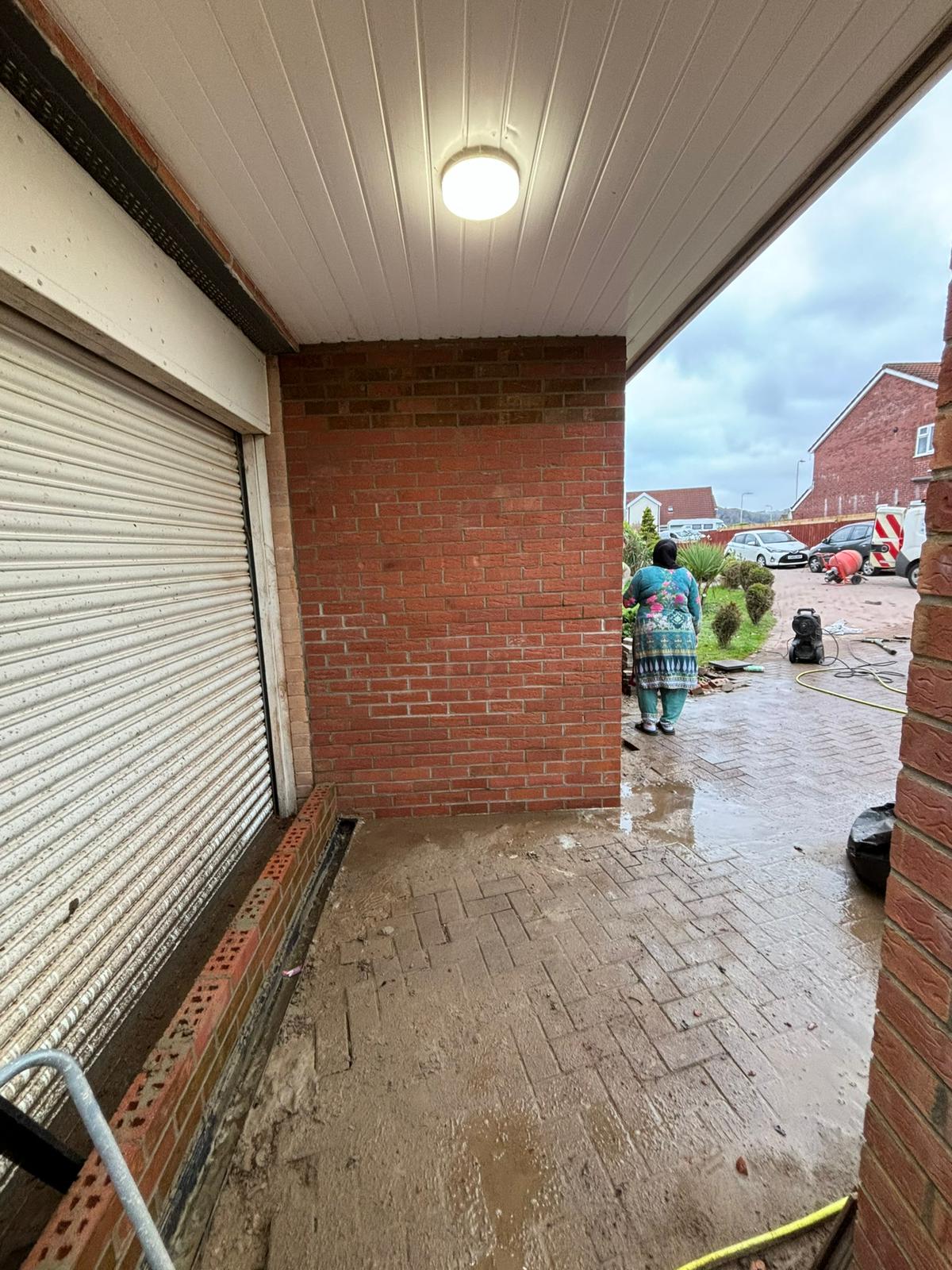 Brick pier and new roller shutter opening on a commercial unit, Aberdare