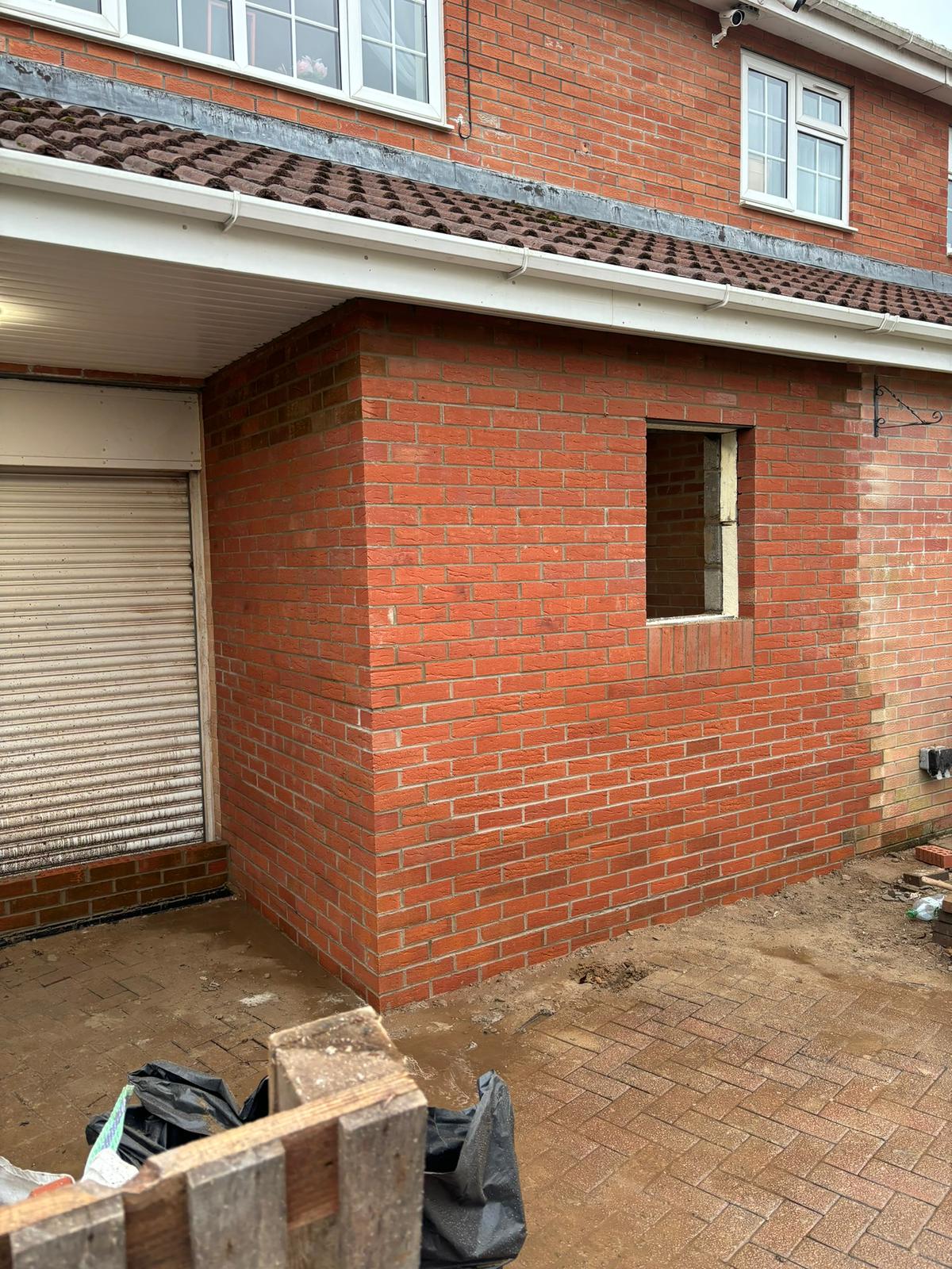 Single-storey brick extension with new window opening, Aberdare